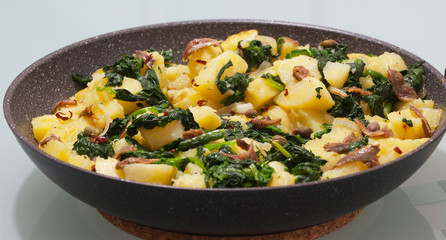 Potatoes with anchovies and spinach.