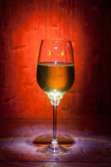 Wine glass on red wooden background