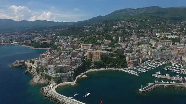 Aerial Flight over historical city of Bastia, important harbour on Corsica island, France, Europe 