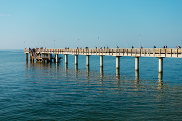 Fototapeta na wymiar Fishermans catching fish from the pier