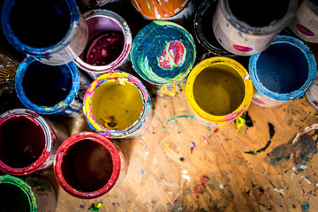 Colourful paint cans on the floor viewed from above - obrazy, fototapety, plakaty