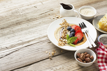 Oatmeal pancakes in a frying pan on wooden table