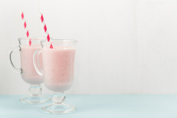 Two ice-cream pink cocktails with strawberries