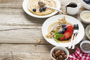 Oatmeal pancakes in a frying pan on wooden table