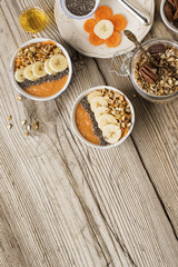 Obraz na płótnie Canvas Healthy breakfast. Carrot Banana smoothie with granola and chia seeds