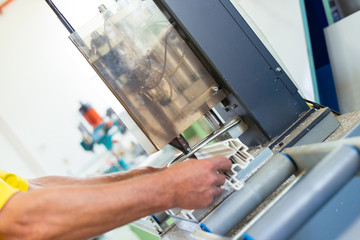 Manual worker assembling PVC doors and windows. Manufacturing jobs. Selective focus. Factory for aluminum and PVC windows and doors production.