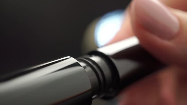 Woman opening new mascara, extreme close up