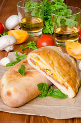 Calzone pizza with ham , mushrooms and corn