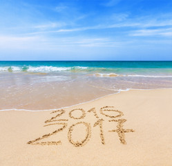 2016 and 2017 on a beach sand