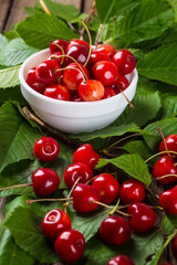 Fresh cherries in bowl on table