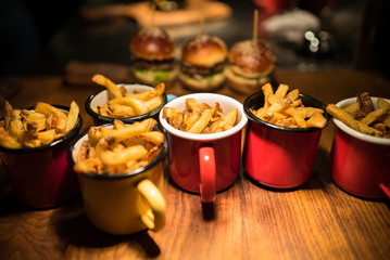 French fries in tin cups served with burgers