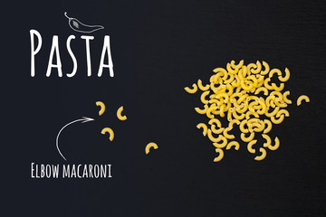Uncooked Italian pasta Elbow macaroni on black slate stone background with white lettering, top view