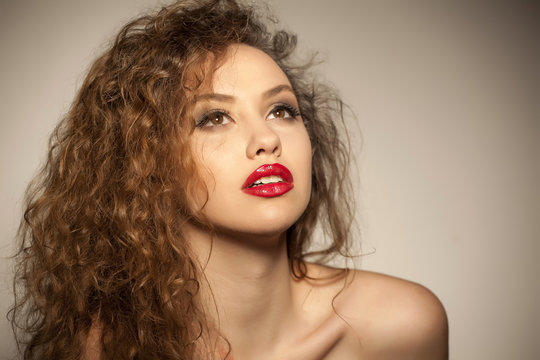 portrait of a beautiful young woman with curly hair