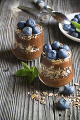 Healthy homemade breakfast. Chocolate banana smoothie with crunchy  granola and fresh berries blueberry