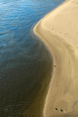 Blue water and yellow beach sand