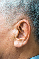 Close up on an ear of an asian elder