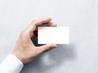 Hand hold blank plain white business card design mockup. Clear calling card mock up template holding arm. Visit pasteboard paper surface display front. Check small offset card print. Business branding