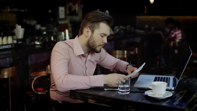 young business man has turned upset working in a bar