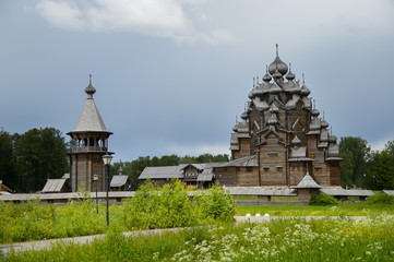 Fototapeta premium The wooden Church of the Intercession of the Holy virgin - active Orthodox temple in the Nevsky forest Park of Vsevolozhsk district of Leningrad region. Copy of Russian wooden Architecture.