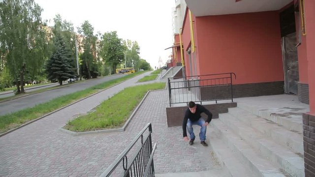 Young man doing parkour exercise with stairs