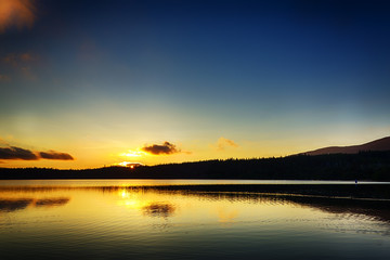 Naklejka na ściany i meble Sunset over Loch Morlich