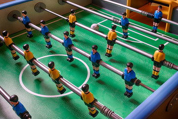 Table football game.Table football in a close up macro with blue and yellow figures.