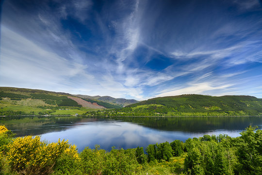 Beautiful Reflections Over Loch Tay, Scotland.  Mountains in the background.  A summers day.