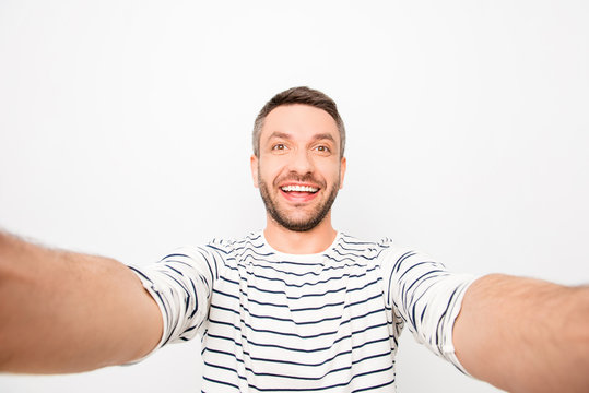 Attractive cheerful happy man making selfie