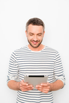 Portrait of happy young guy holding digital tablet