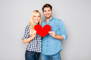 Young happy couple in love holding paper heart