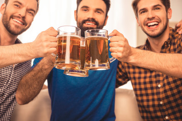 cheers! Close up photo of handsome men celebrating  and clinking