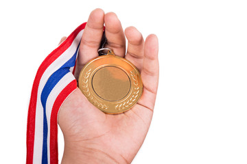 Fototapeta premium Athlete holding generic gold medal with ribbon on his hand