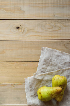 two pears and linen fabric on wooden a table