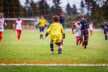 Young soccer goalie preparing to make a save