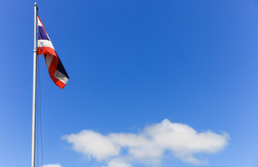 National flag of Thailand with blue sky background.