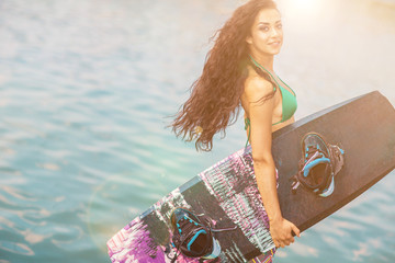 Young attractive woman with wakeboard