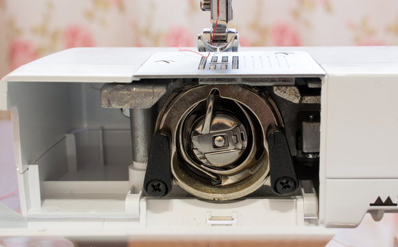 Metal bobbin inside of a sewing machine
