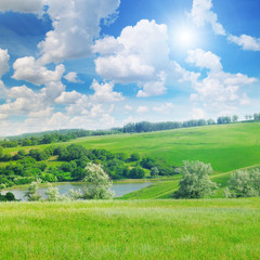 Fototapeta na wymiar picturesque green field and blue sky