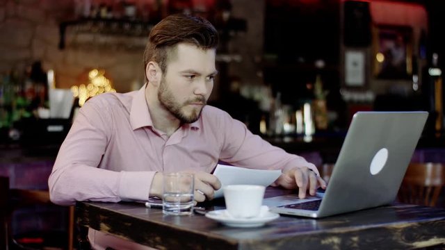 young business man has turned upset working in a bar