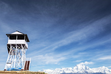 Fototapeta premium The tower on the hill, sky with clouds.