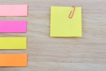 Color  Paper notes with sticky note on Wood Background