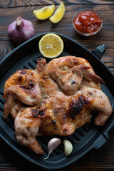 Cast-iron grill with roasted chicken tobacco, selective focus
