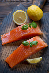 Close-up of smoked trout fillet with lemon and green basil