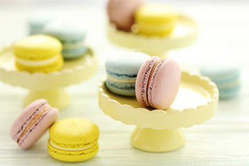 French colorful macarons on a white wooden table