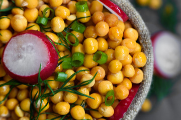 background of wet peas sprinkled with dill and radish