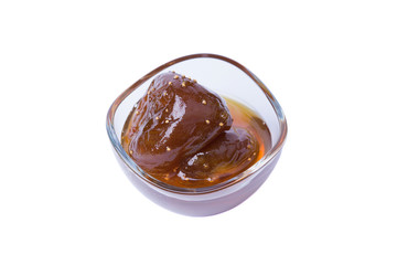 Homemade fig jam in a glass bowl isolated on white