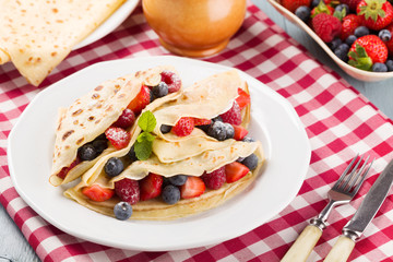Delicious pancakes with raspberries, blueberries and strawberrie