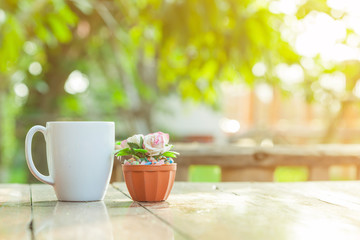 rose flower and coffee cup decoration with blue garden background