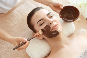 Young beautiful woman having spa procedure on her face