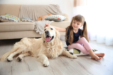 Little girl and big kind dog in the living room